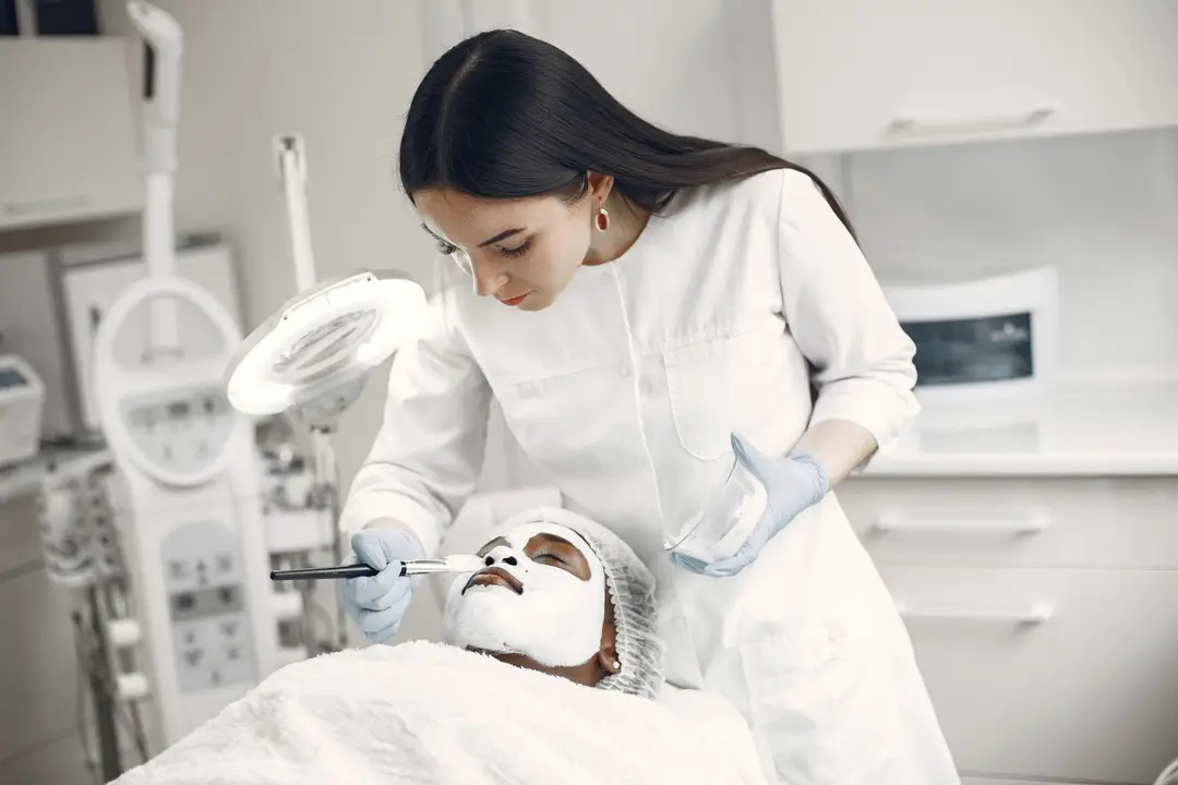 A skincare professional applying a facial treatment to a client
